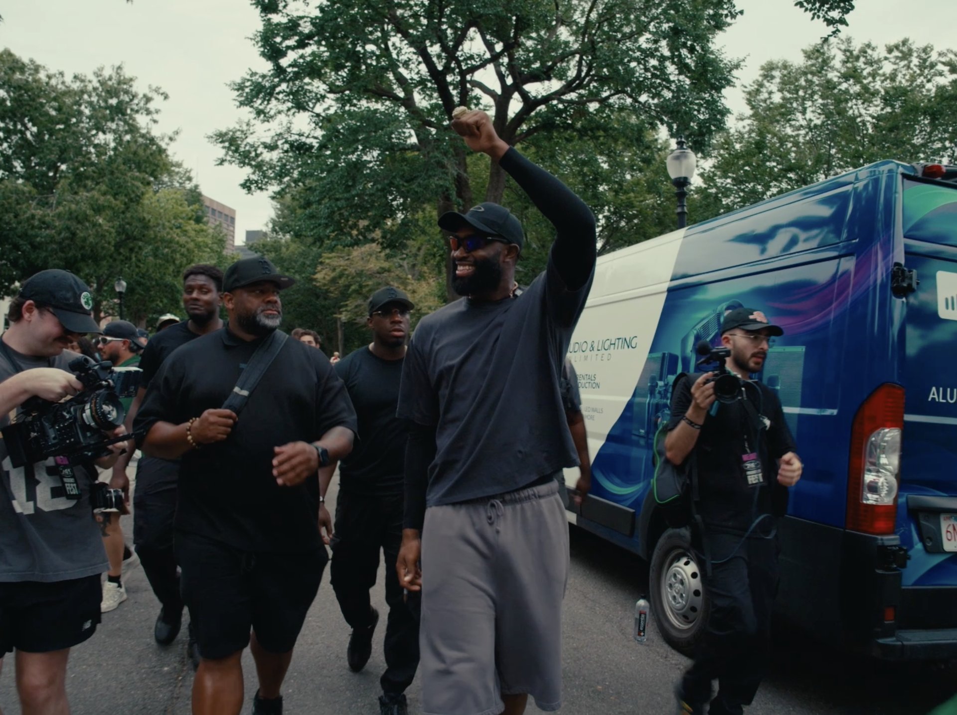 Jaylen Brown pumping his fist while walking through the crowd with his crew