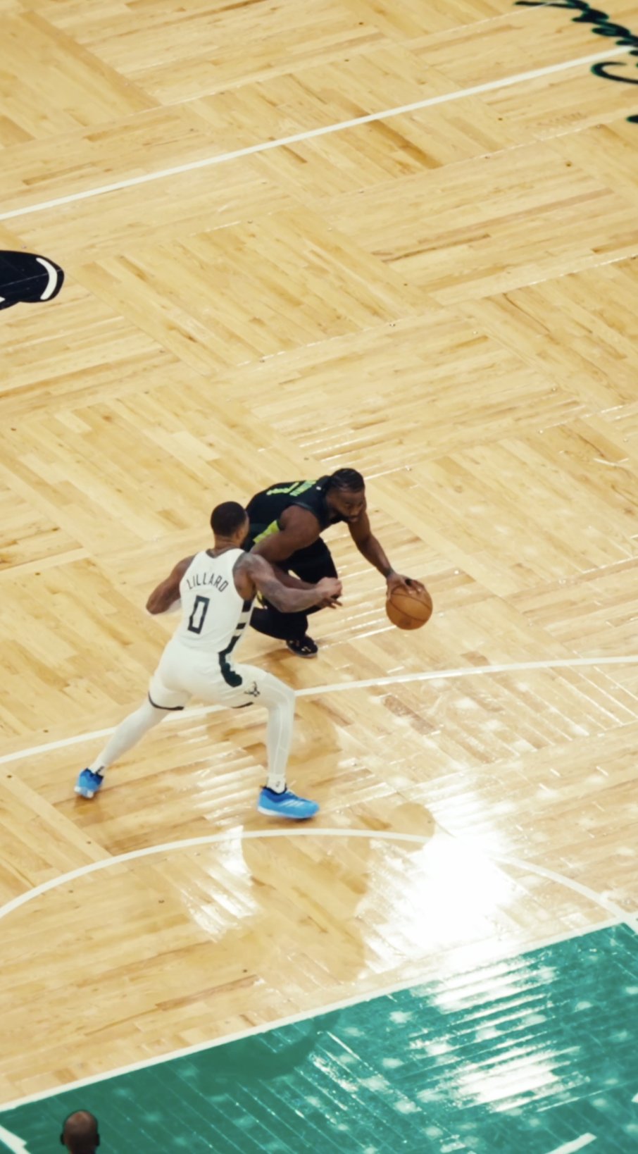 Overhead court shot of Jaylen Brown dribbling against Damian Lillard