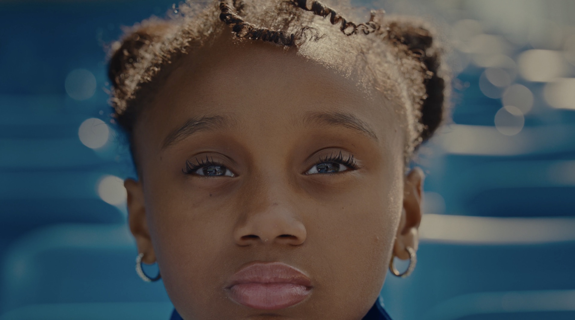 Close-up portrait of a young athlete with hair in space buns