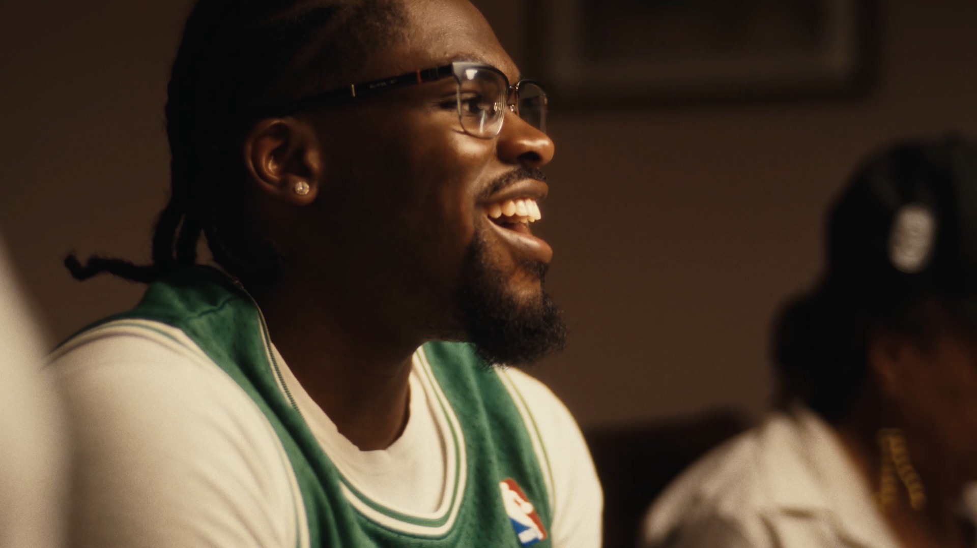 Portrait, laughing, in a green Celtics jacket