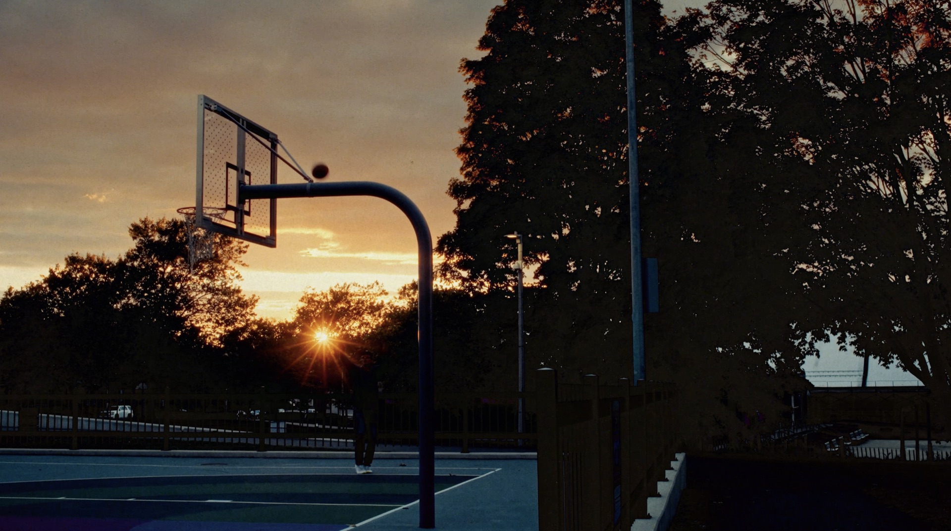 Basketball hoop silhouette at sunset