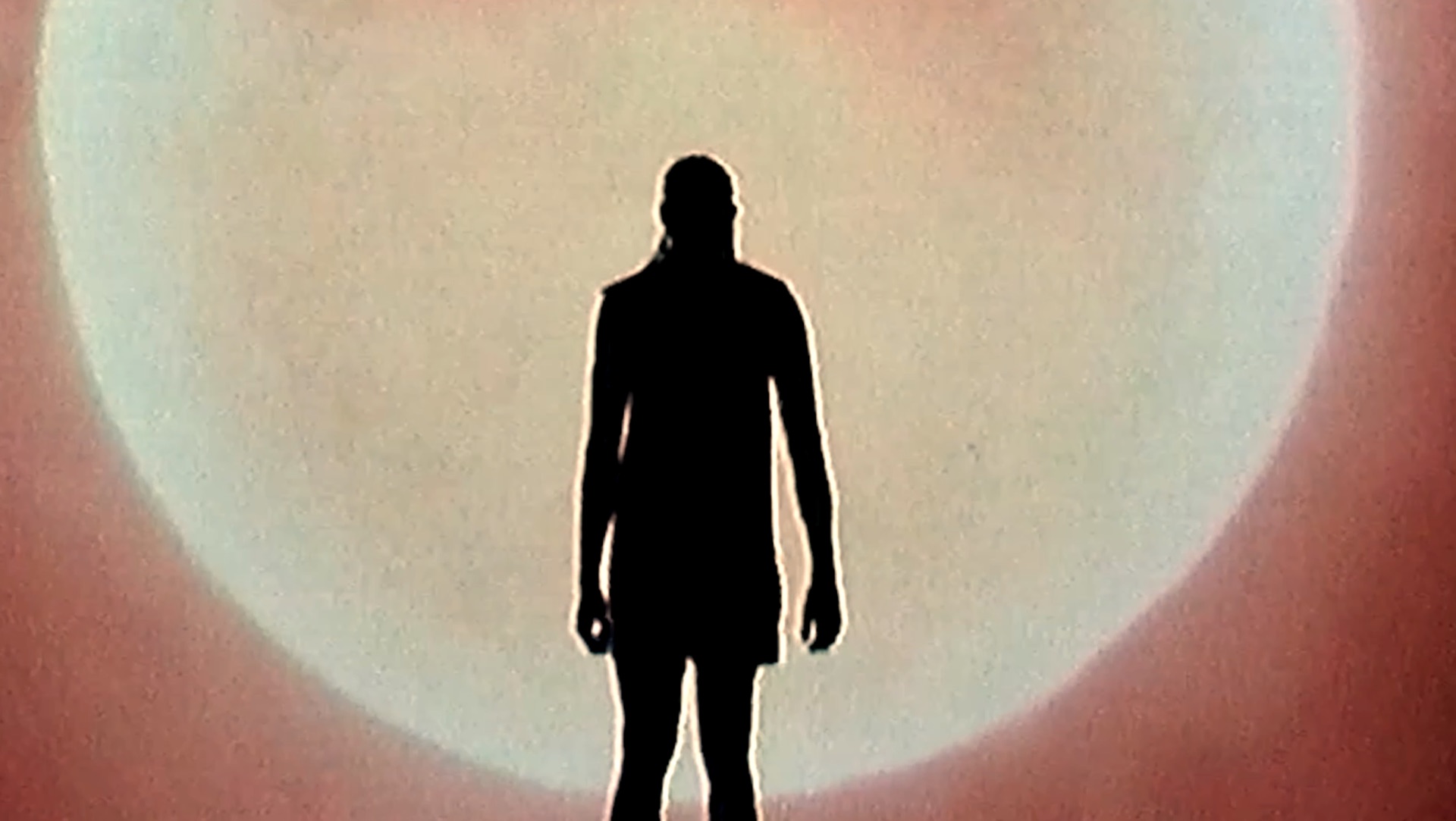 Player silhouetted mid-dribble, backlit by a glowing sun