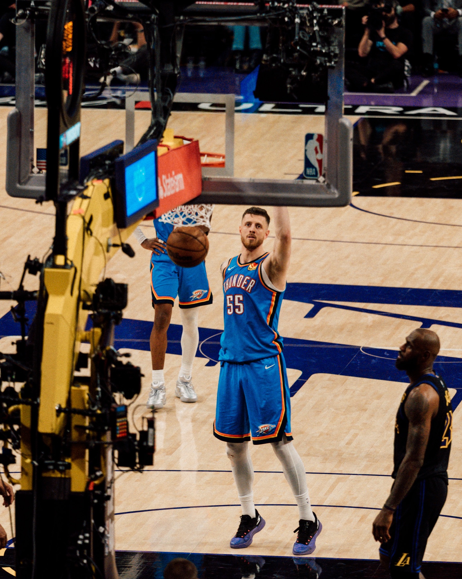 Isaiah Hartenstein dunking on court, teammate and defender looking on