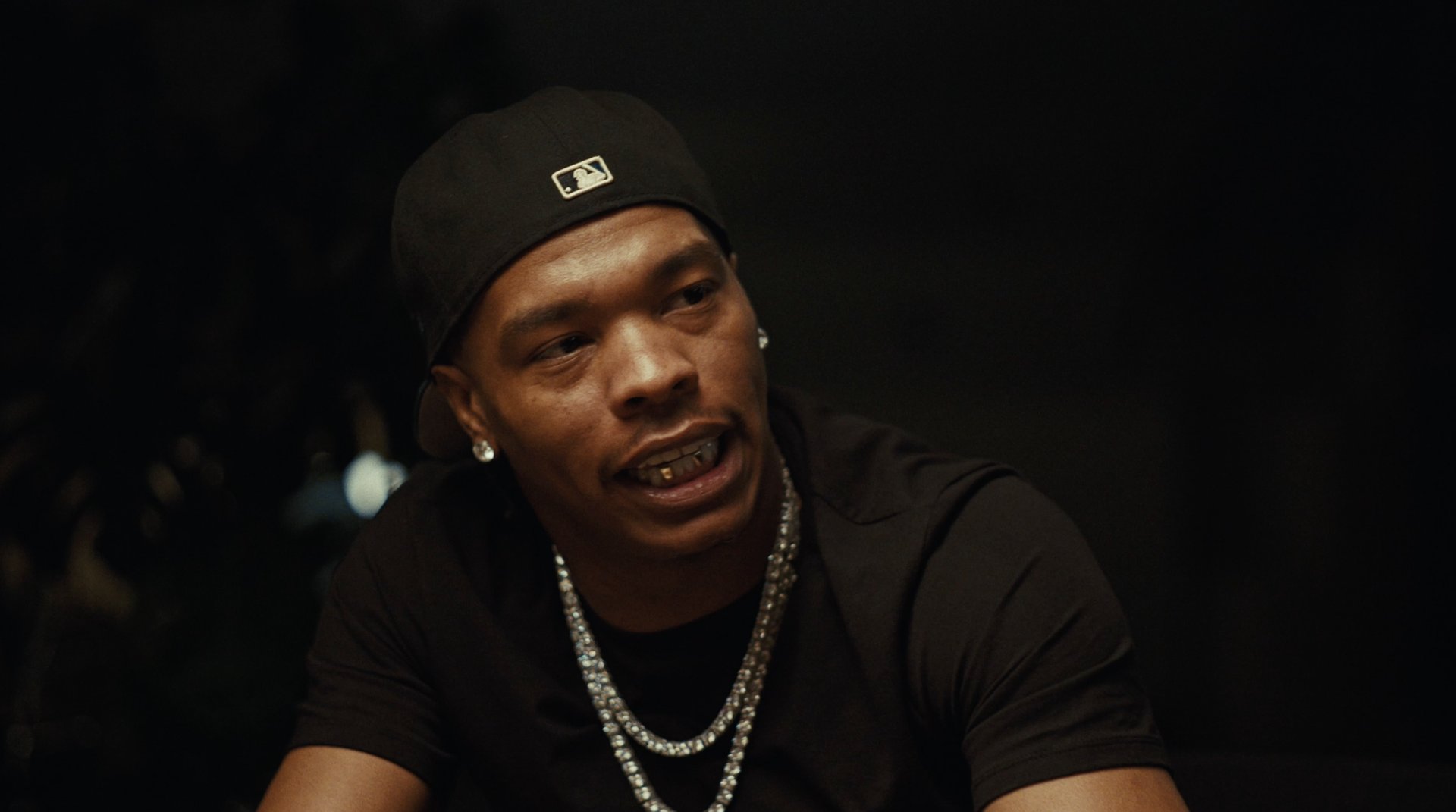 Lil Baby speaking, chains catching the light