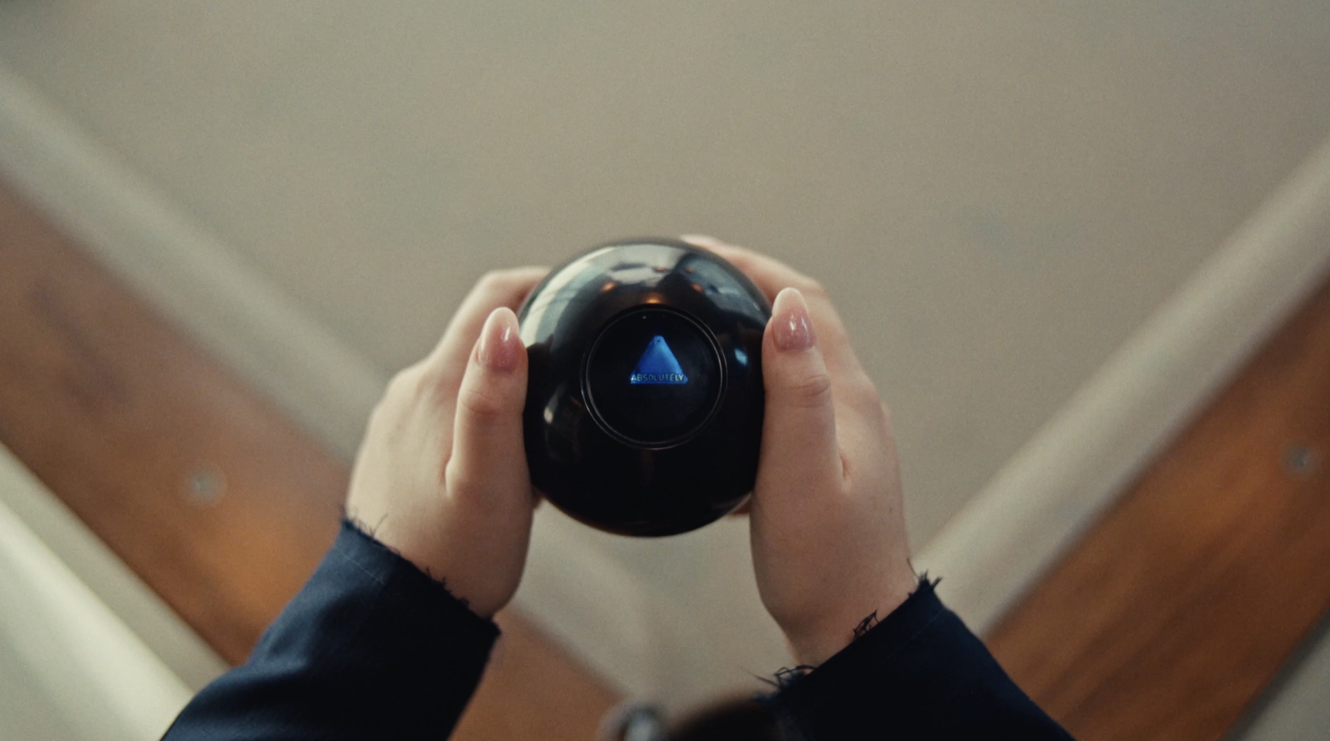 Hands holding a Magic 8-Ball reading "Absolutely"