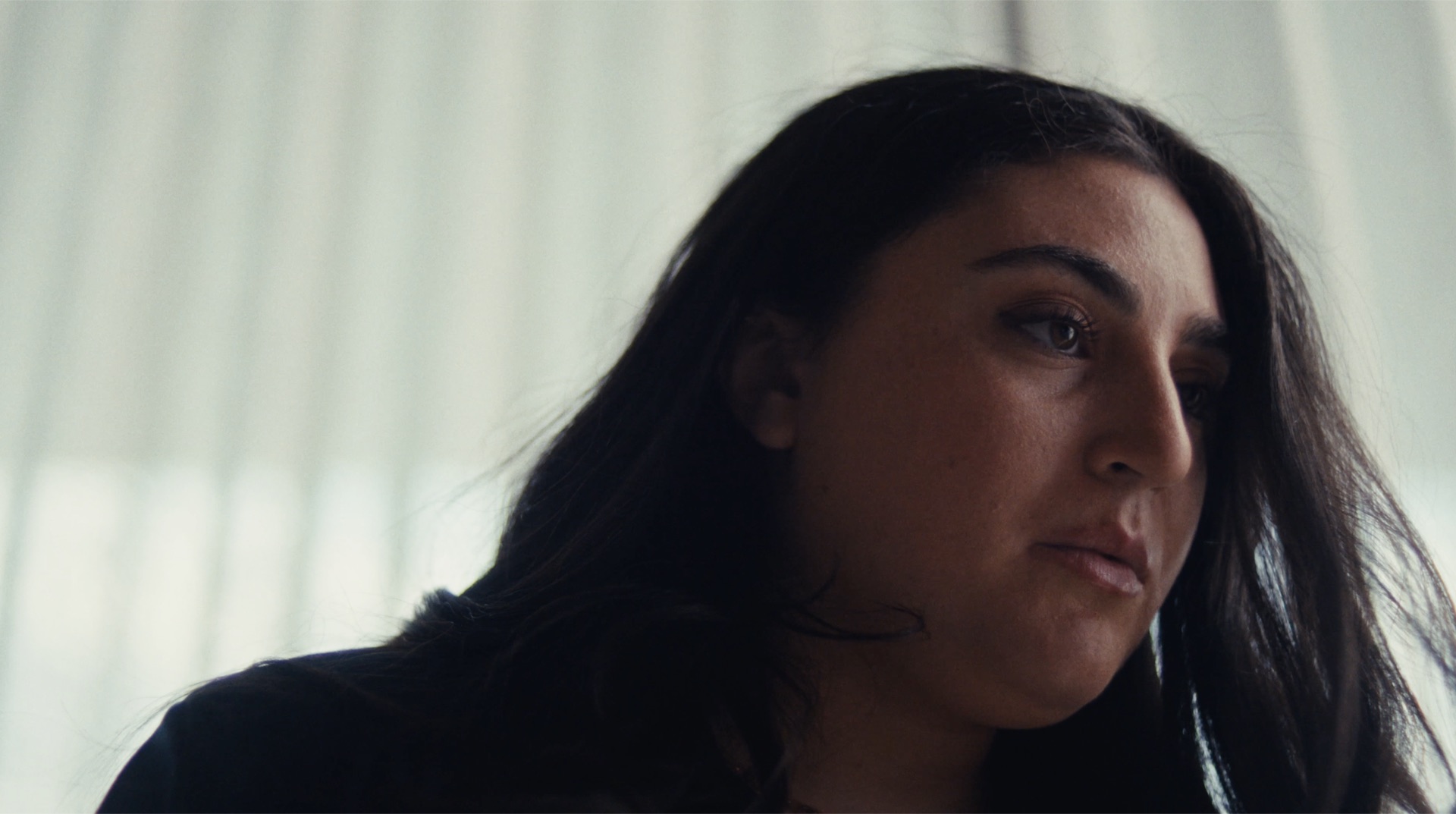 Profile portrait in low, moody light