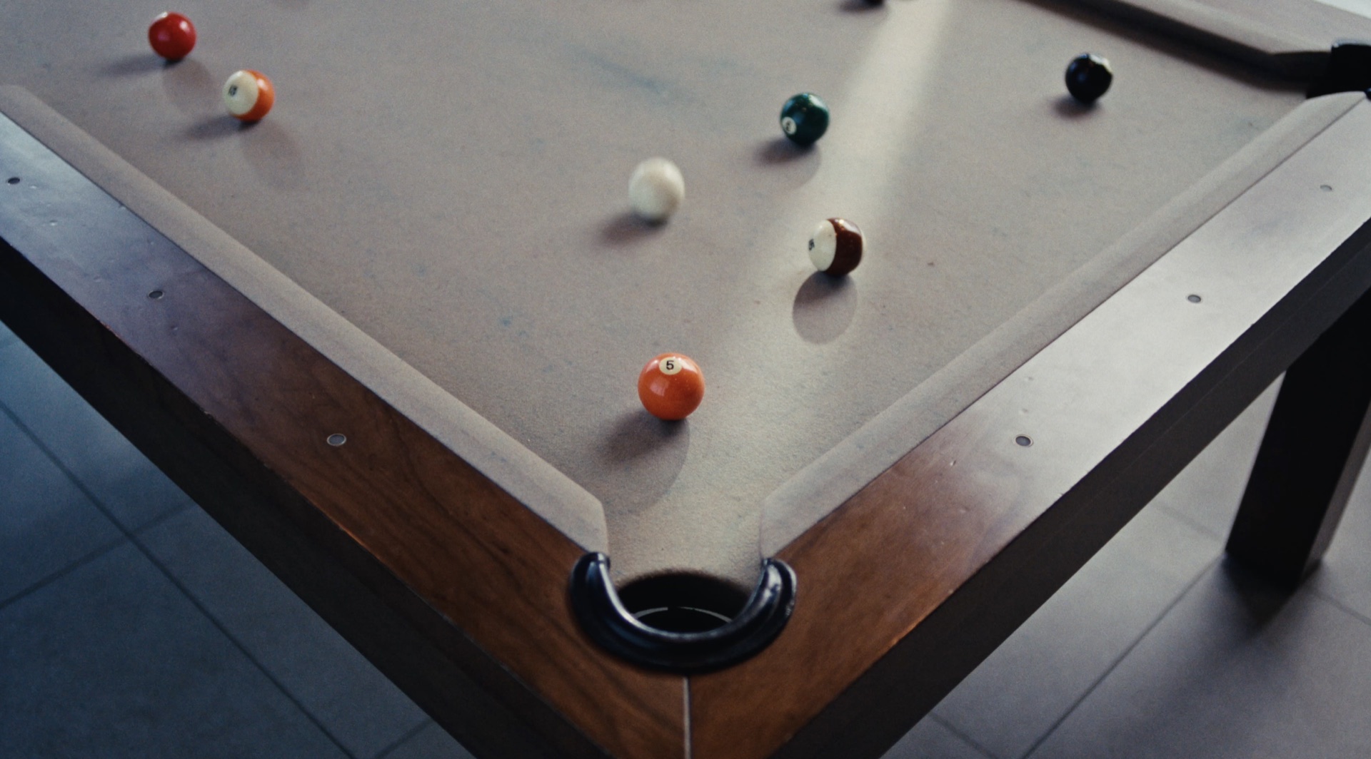 Macro shot of chalk dust lifting off a pool cue tip