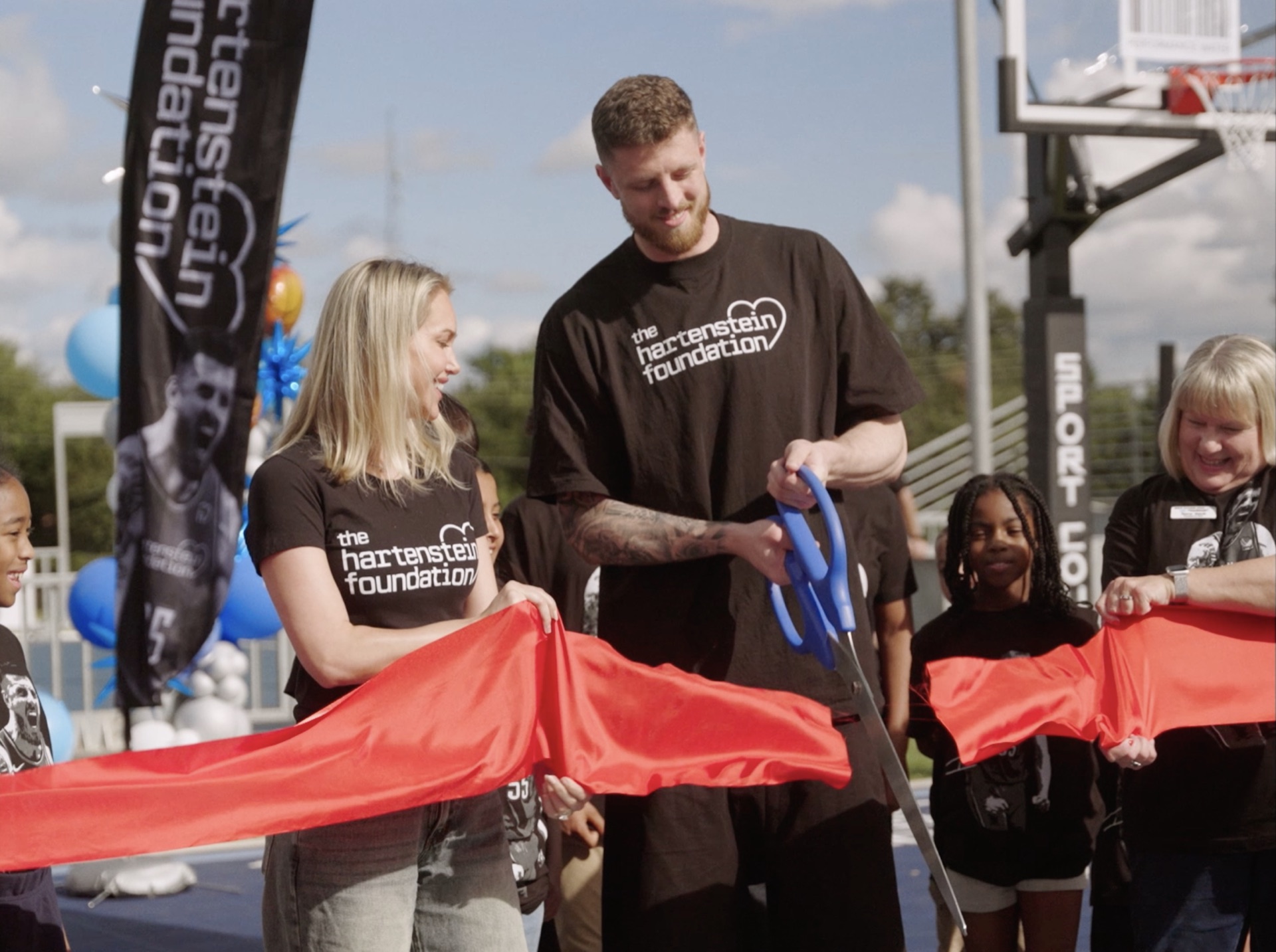 Ribbon-cutting for a new community basketball court, the Hartenstein Foundation